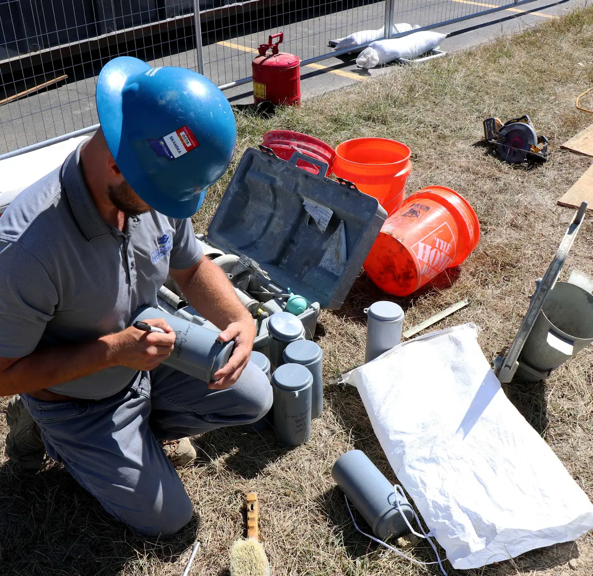 Civil Solutions field technician labeling concrete test cylinders
